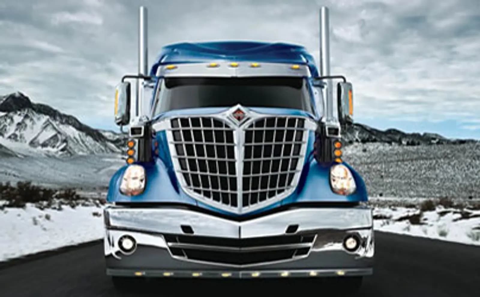 Heavy haul truck hauling equipment at sunrise