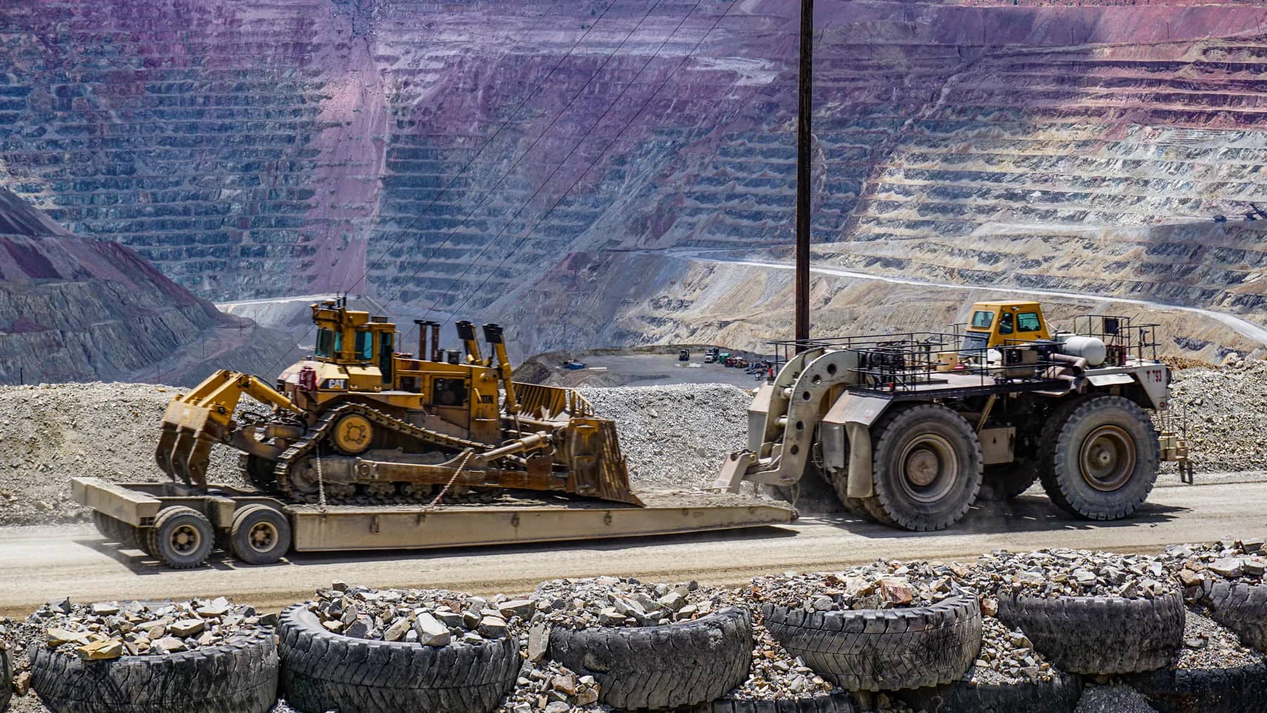 Multi-axle RGN hauling a Caterpillar D11 dozer in a mine quarry.