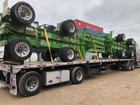 Chrome tractor staged for an open-deck haul.