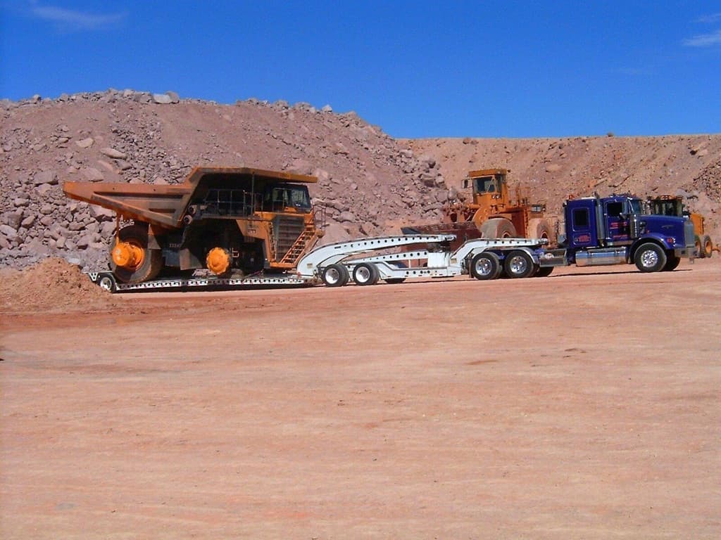 Multi-axle trailer hauling large mining equipment